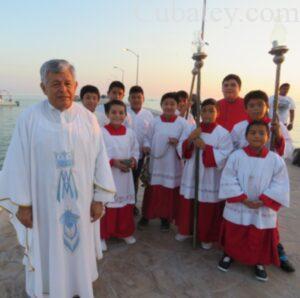 El párroco Lorenzo Mex Jiménez en la procesión en el mar.